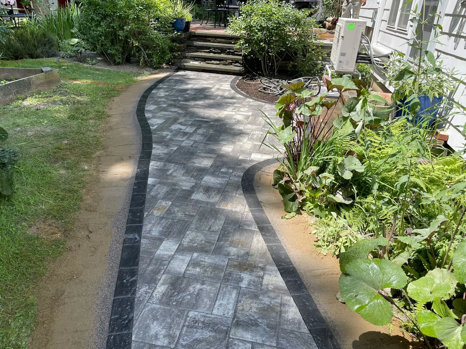 Curved paver walkway with dark border