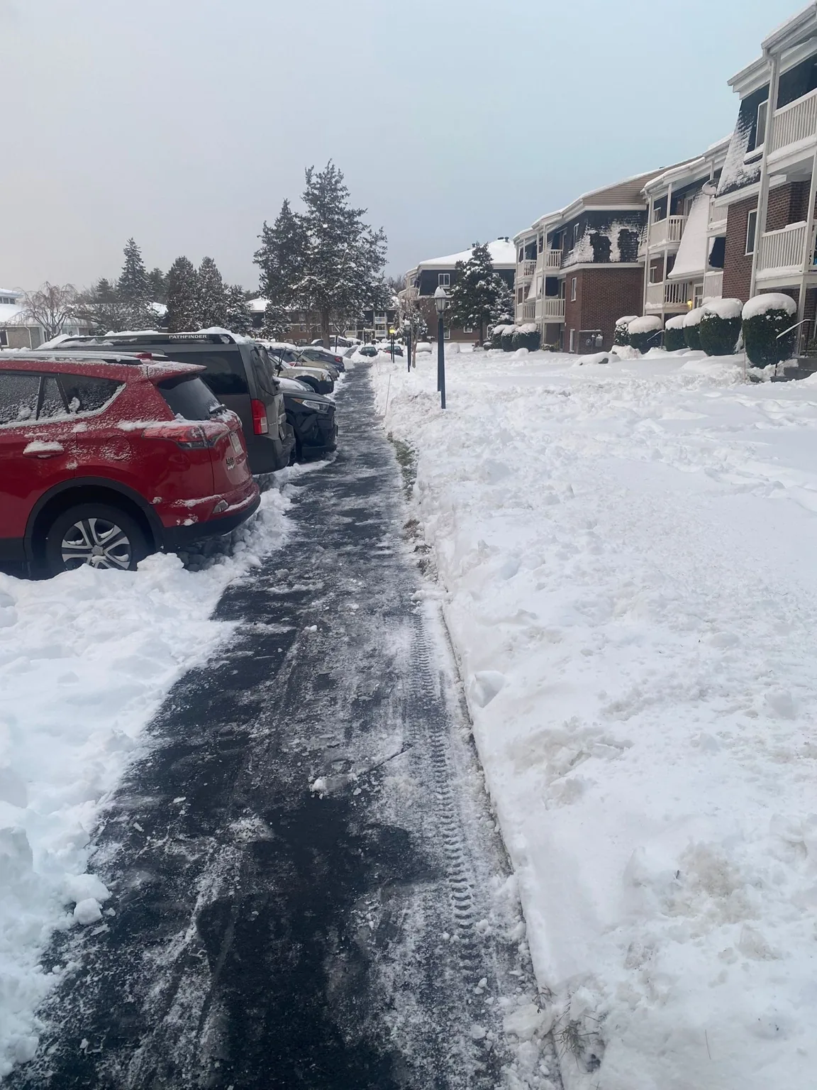 Truck snow plowing a commercial facility